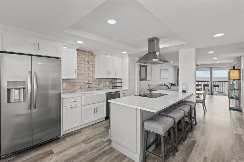 14950 Gulf Boulevard, Unit 503 Madeira Beach, FL 33708 - Photo 9 of 43 a kitchen with stainless steel appliances a stove a sink a refrigerator and cabinets