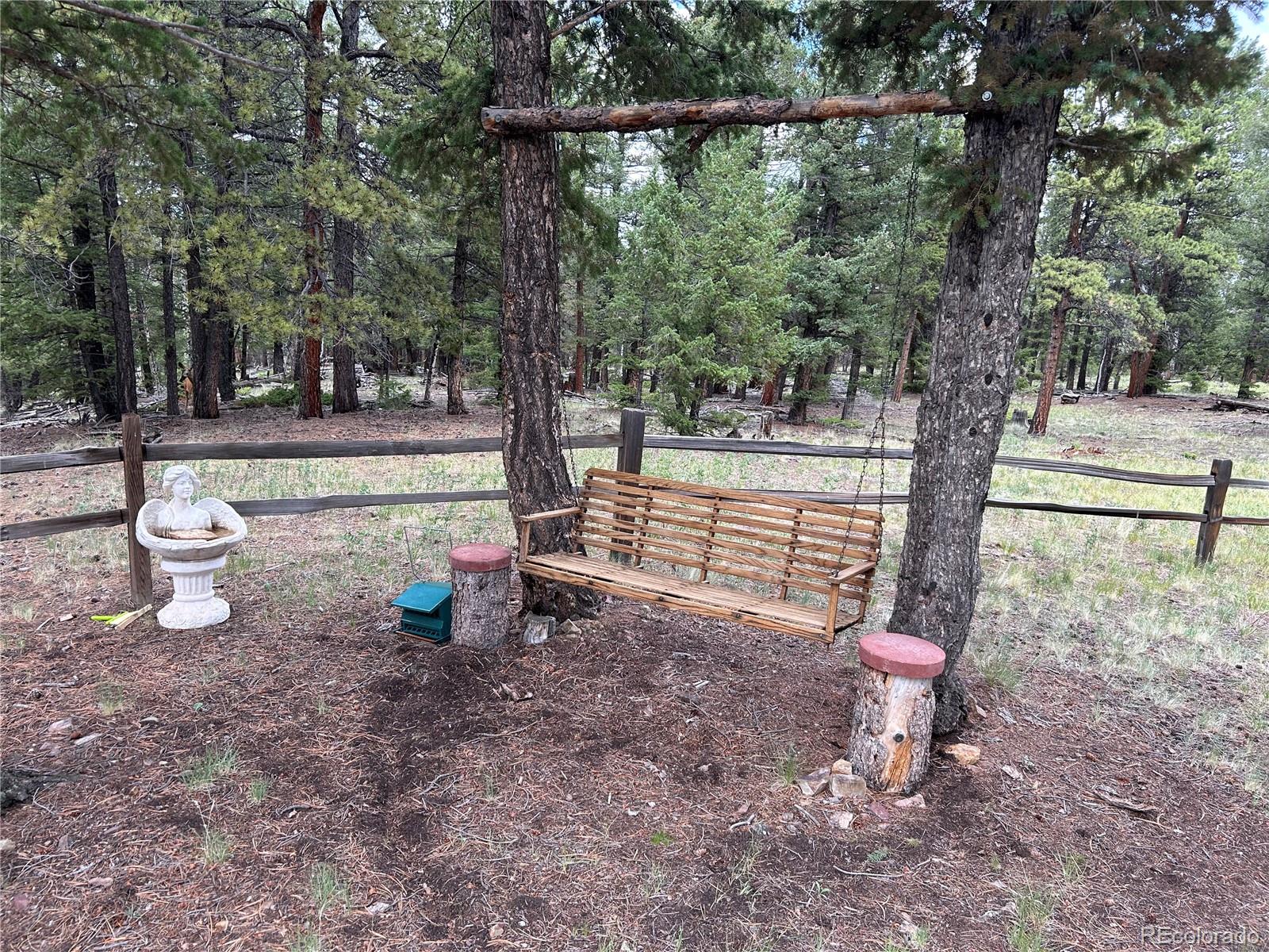 2130 Pitchfork Road Hartsel, CO 80449 - Photo 17 of 30 a backyard of a house with table and chairs