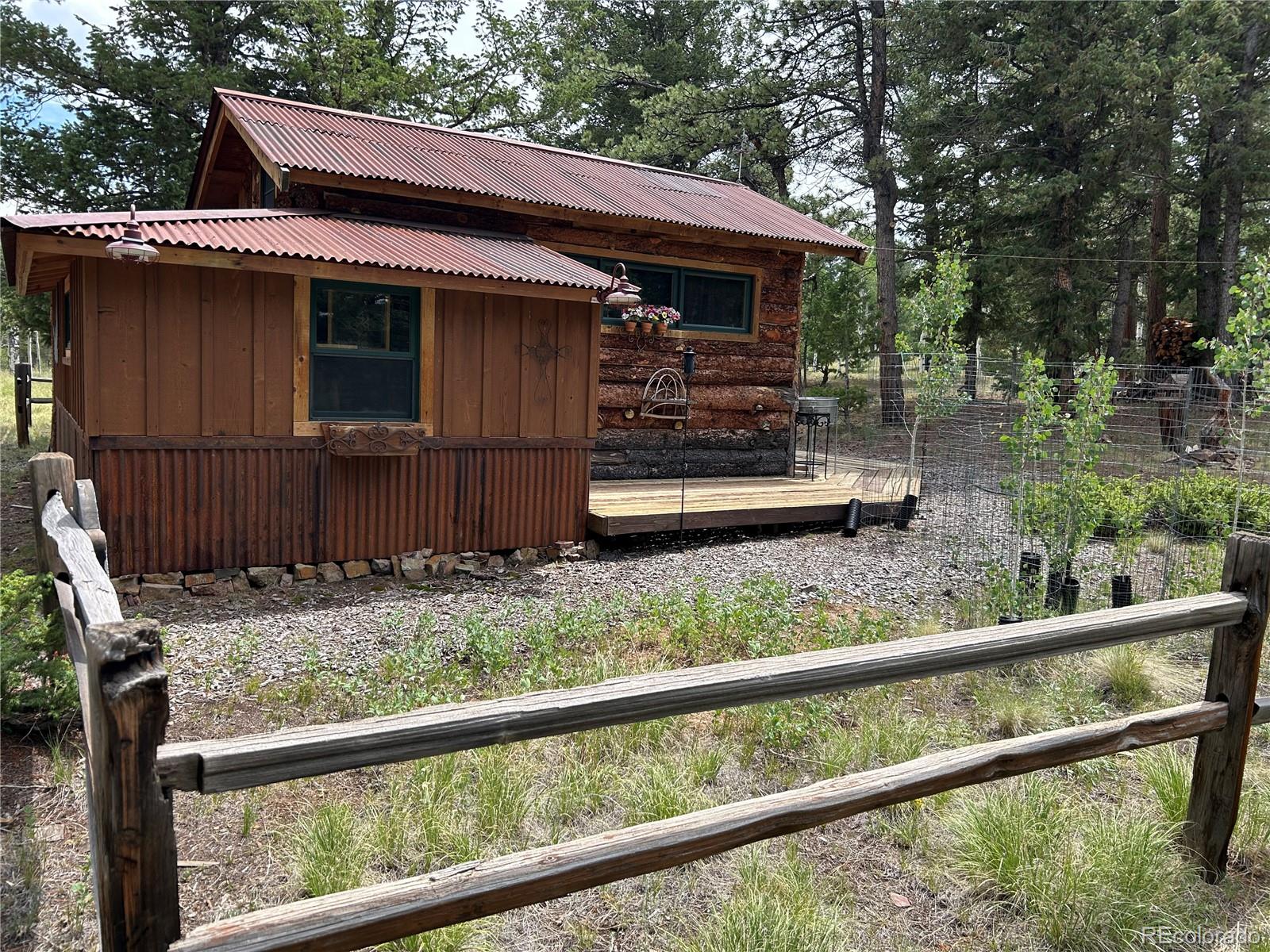 2130 Pitchfork Road Hartsel, CO 80449 - Photo 3 of 30 a backyard of a house with wooden deck and outdoor seating