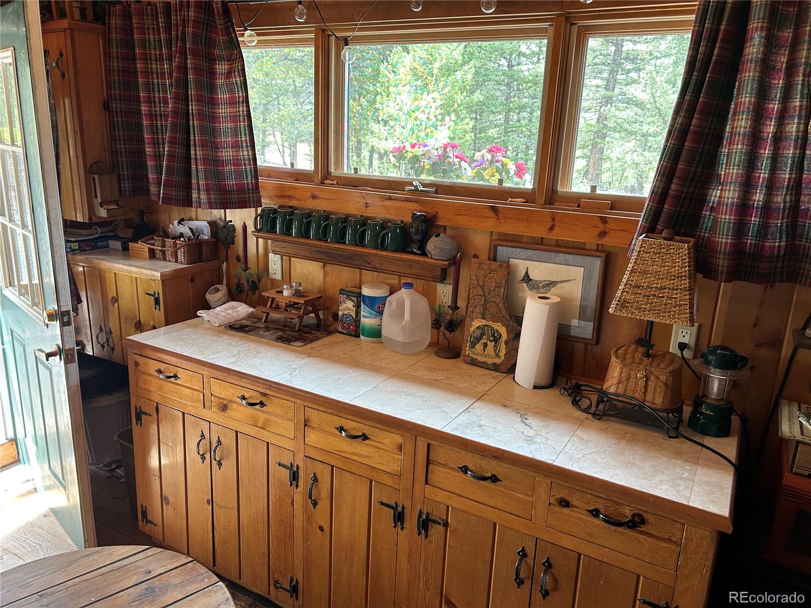 2130 Pitchfork Road Hartsel, CO 80449 - Photo 7 of 30 a kitchen with granite countertop a stove a sink and a cabinets