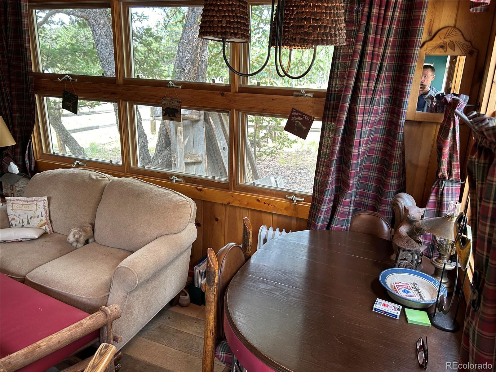 2130 Pitchfork Road Hartsel, CO 80449 - Photo 8 of 30 a living room with furniture and a floor to ceiling window