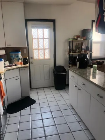 a kitchen with stainless steel appliances a sink a stove a microwave a counter top space and cabinets