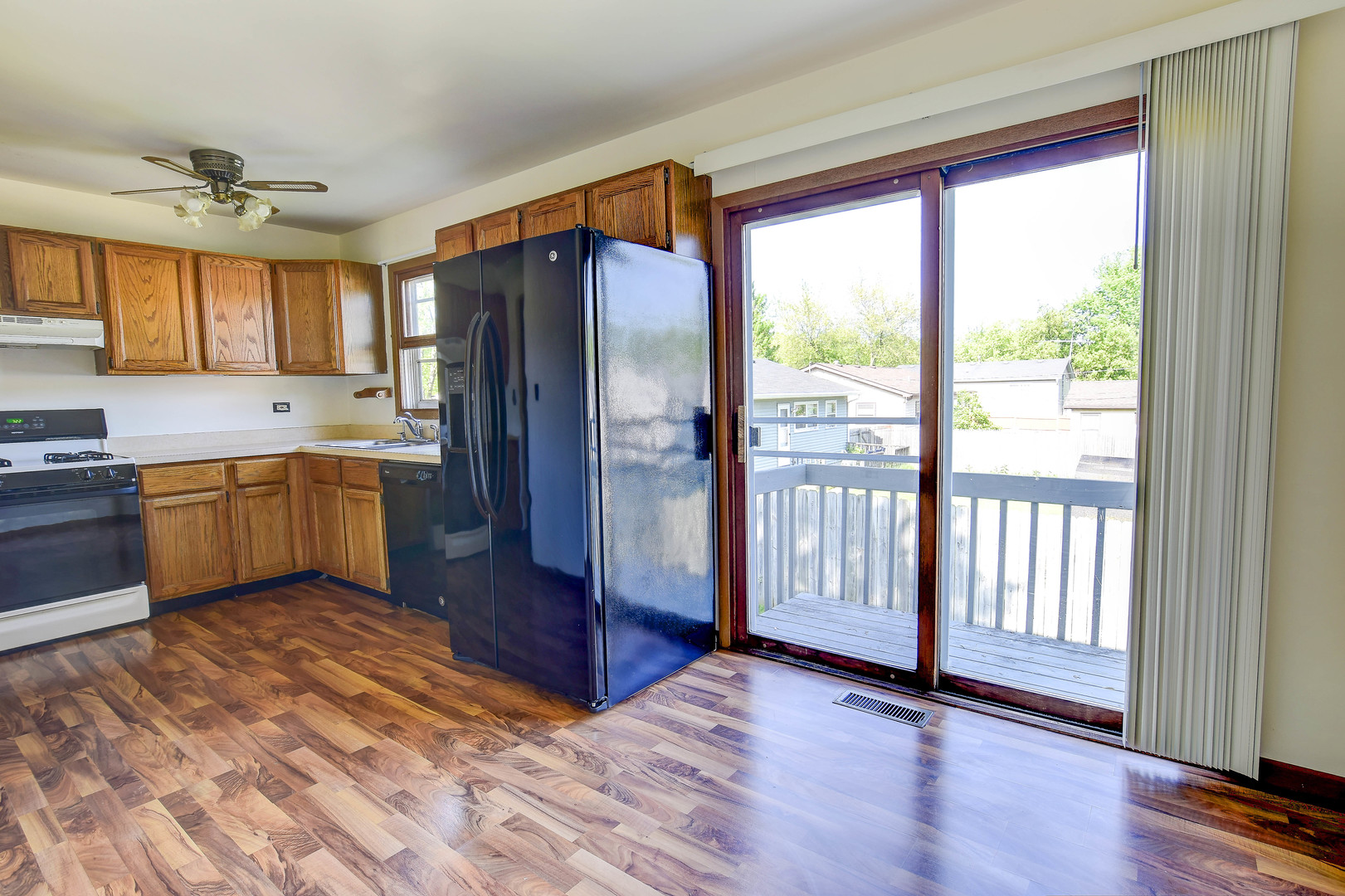 11415 West Edgewood Road Beach Park, IL 60087 - Photo 14 of 29 a kitchen with stainless steel appliances granite countertop a refrigerator a sink and dishwasher with wooden floor