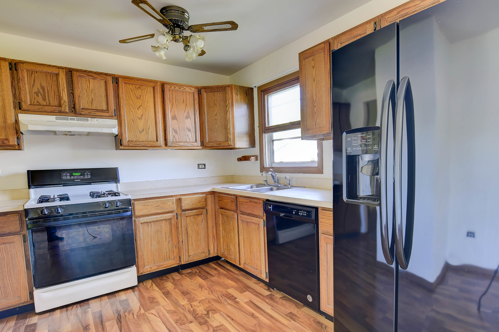 11415 West Edgewood Road Beach Park, IL 60087 - Photo 15 of 29 a kitchen with stainless steel appliances granite countertop a refrigerator a sink dishwasher a stove and white countertops with wooden floor