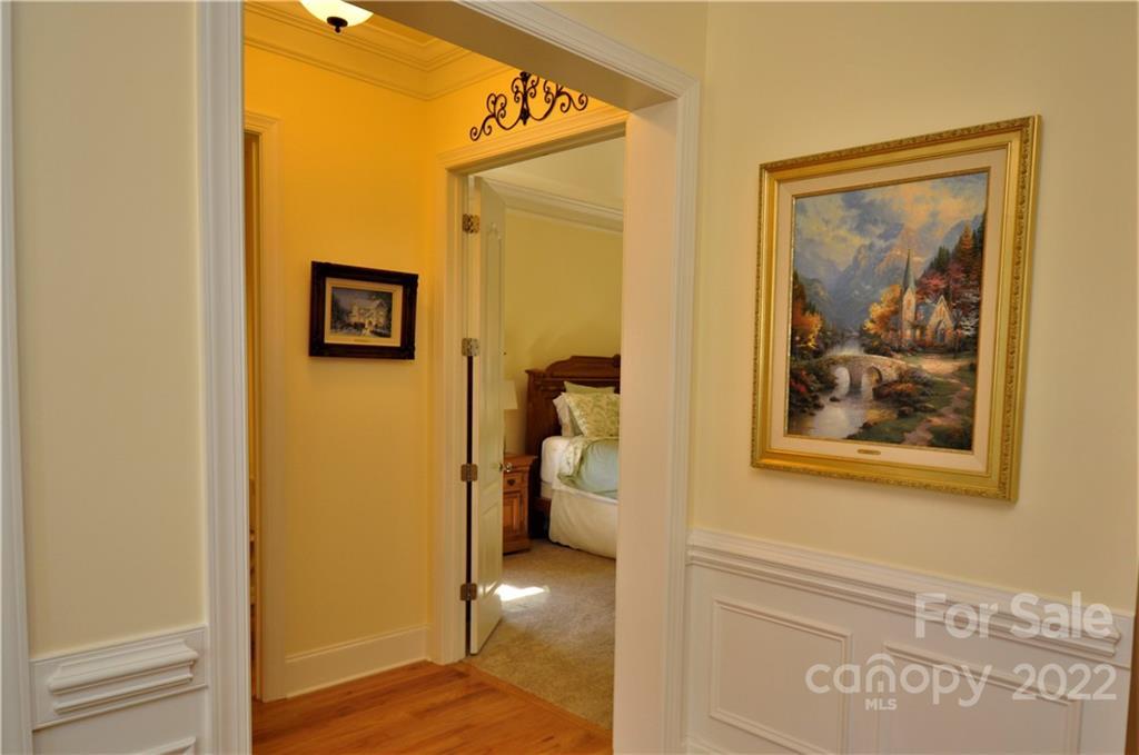 186 Chaska Loop Troutman, NC 28166 - Photo 11 of 48 a view of a hallway with wooden shelves