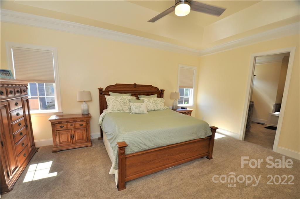 186 Chaska Loop Troutman, NC 28166 - Photo 14 of 48 a bedroom with a bed and a couch