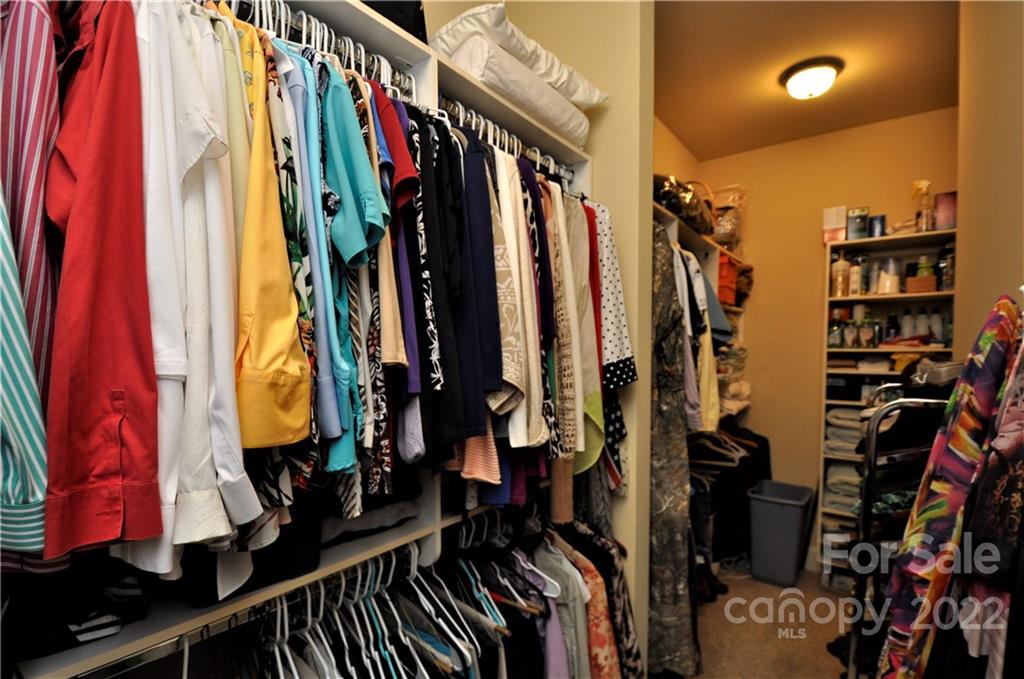 186 Chaska Loop Troutman, NC 28166 - Photo 20 of 48 a view of walk in closet with clothes and shoes