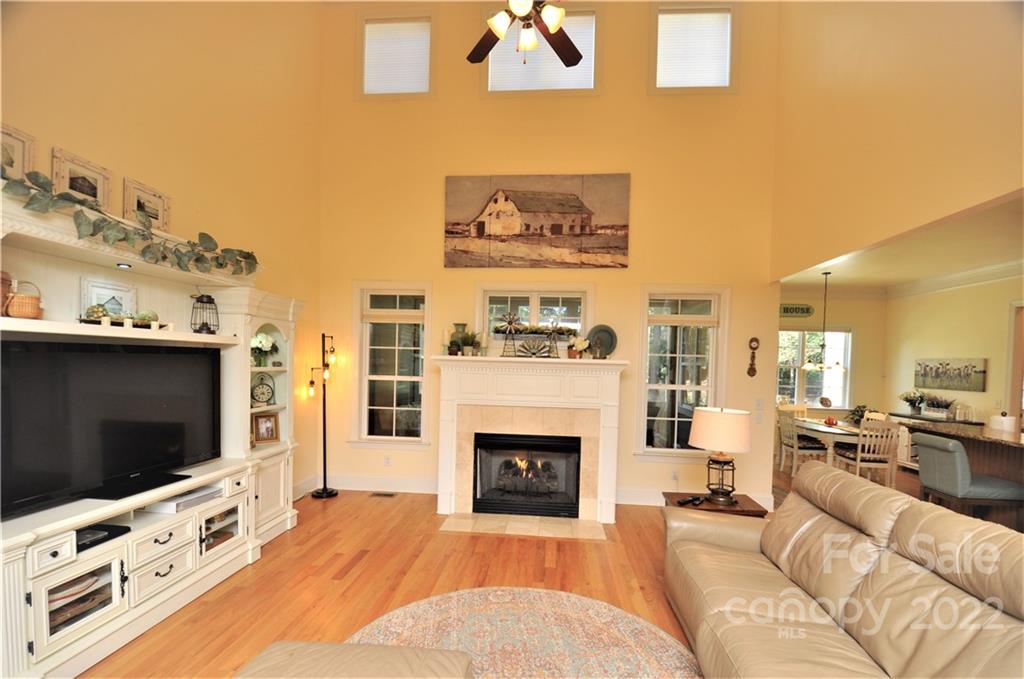 186 Chaska Loop Troutman, NC 28166 - Photo 21 of 48 a living room with furniture a flat screen tv and a fireplace
