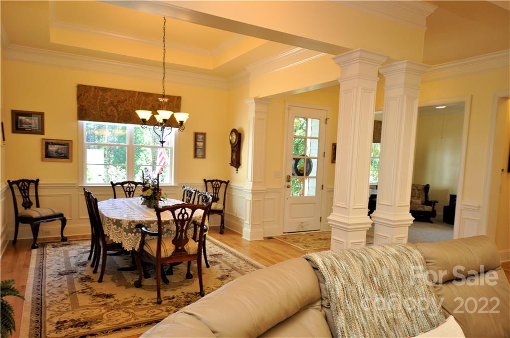 186 Chaska Loop Troutman, NC 28166 - Photo 24 of 48 a view of a dining room with furniture window and wooden floor
