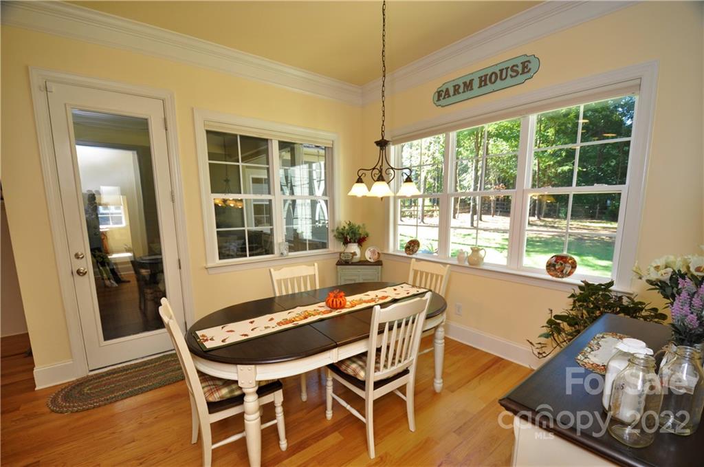 186 Chaska Loop Troutman, NC 28166 - Photo 28 of 48 a dining room with furniture and large windows