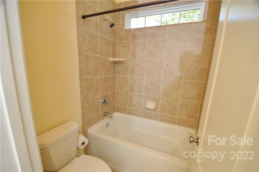 186 Chaska Loop Troutman, NC 28166 - Photo 35 of 48 a bathroom with a bathtub and a shower