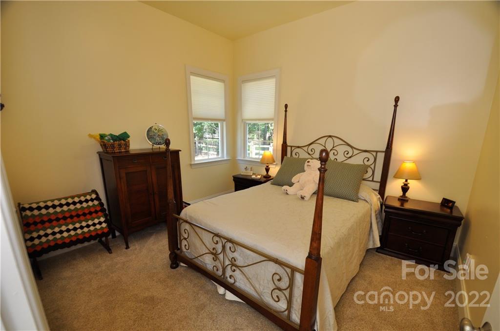 186 Chaska Loop Troutman, NC 28166 - Photo 36 of 48 a bed room with a bed and a chair