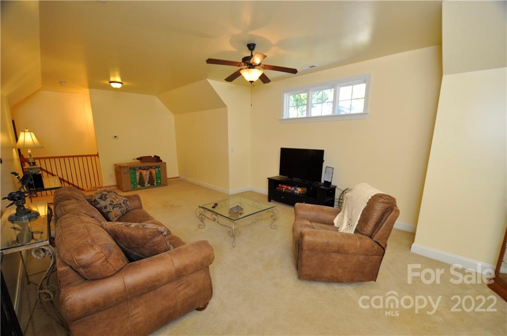 186 Chaska Loop Troutman, NC 28166 - Photo 39 of 48 a living room with furniture and a flat screen tv