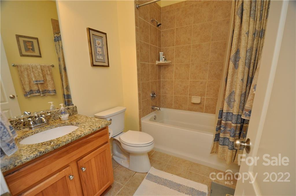 186 Chaska Loop Troutman, NC 28166 - Photo 42 of 48 a bathroom with a granite countertop sink toilet and shower