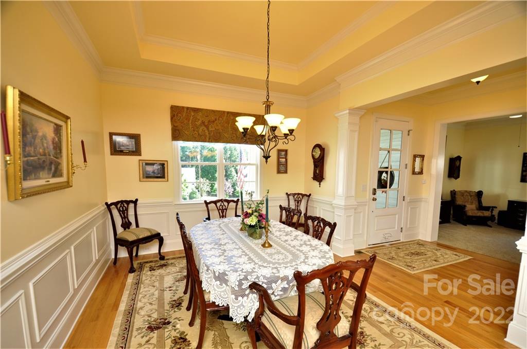 186 Chaska Loop Troutman, NC 28166 - Photo 8 of 48 a view of a dining room with furniture and a chandelier