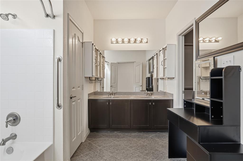 1017 Long Pointe Avenue Fort Worth, TX 76108 - Photo 18 of 28 a large bathroom with a double vanity sink a mirror and a bathtub