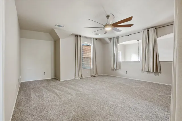 a view of a livingroom with a ceiling fan and window