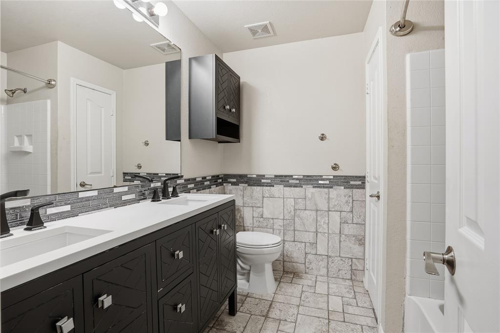 1017 Long Pointe Avenue Fort Worth, TX 76108 - Photo 21 of 28 a bathroom with a double vanity sink toilet and mirror