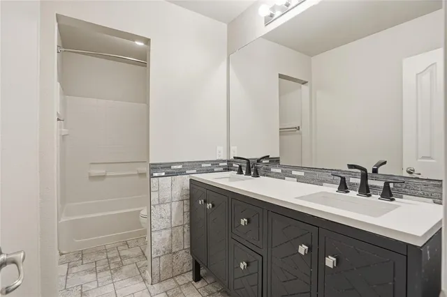 a bathroom with a sink double vanity and a mirror