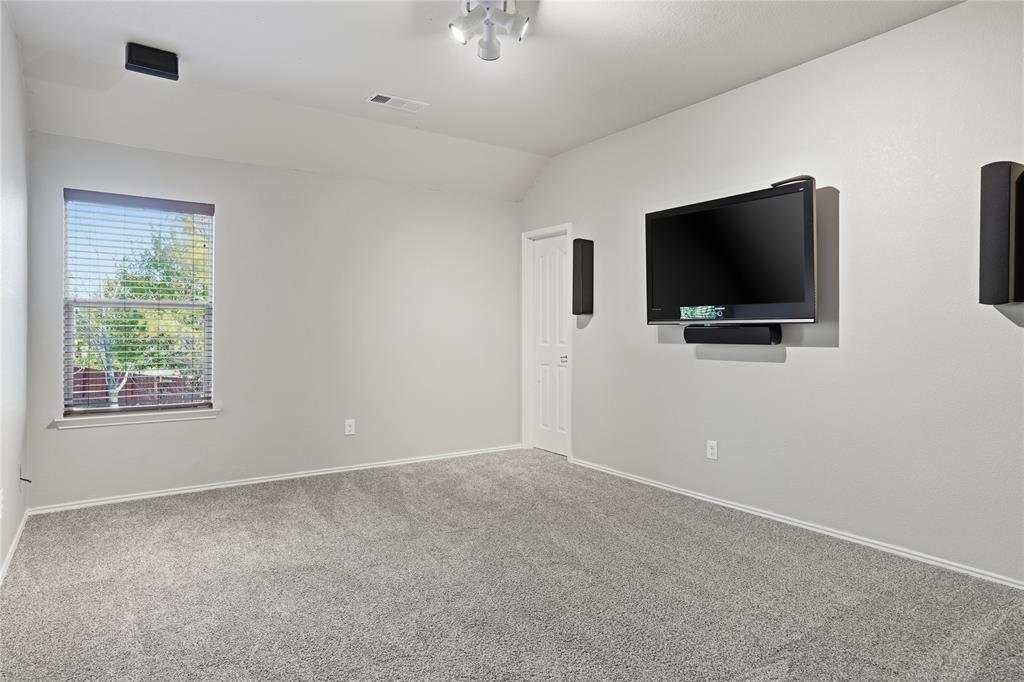 1017 Long Pointe Avenue Fort Worth, TX 76108 - Photo 23 of 28 a livingroom with a flat screen tv