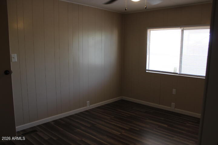 303 South Recker Road, Unit 38 Mesa, AZ 85206 - Photo 13 of 19 an empty room with wooden floor and windows