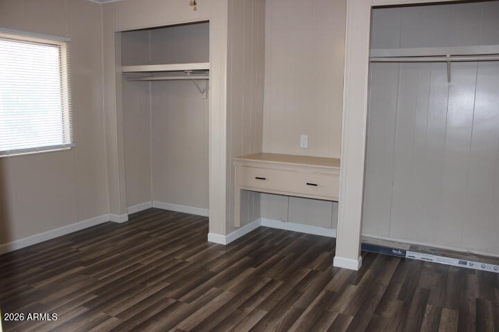 303 South Recker Road, Unit 38 Mesa, AZ 85206 - Photo 14 of 19 a view of an empty room with wooden floor closet and a window
