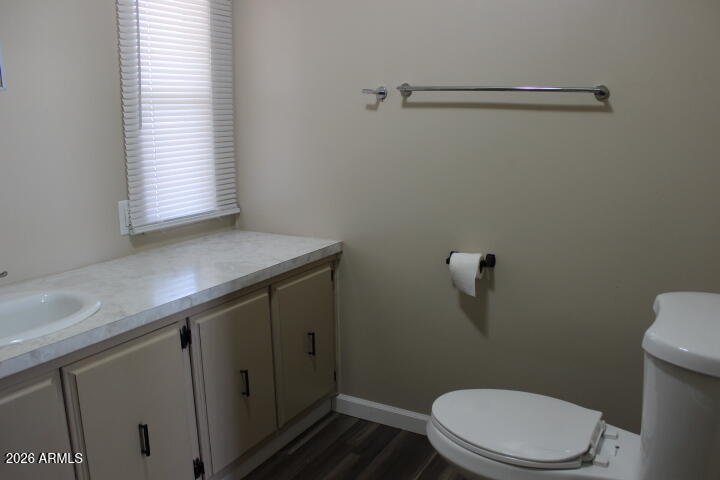 303 South Recker Road, Unit 38 Mesa, AZ 85206 - Photo 15 of 19 a bathroom with a granite countertop toilet and a sink