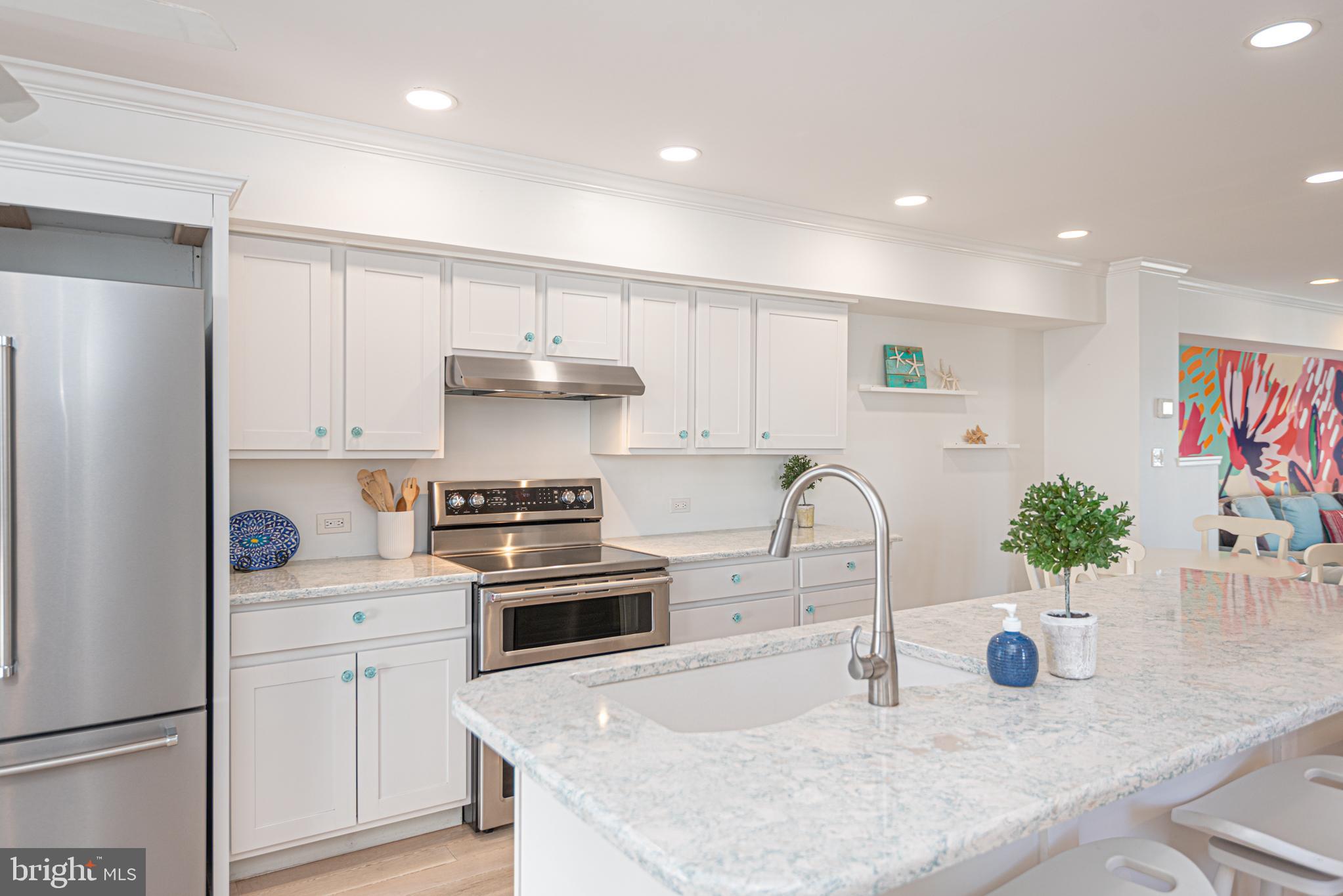 37845 Salt Grass Cove, Unit 89 Ocean View, DE 19970 - Photo 13 of 83 a kitchen with stainless steel appliances granite countertop a sink stove and refrigerator