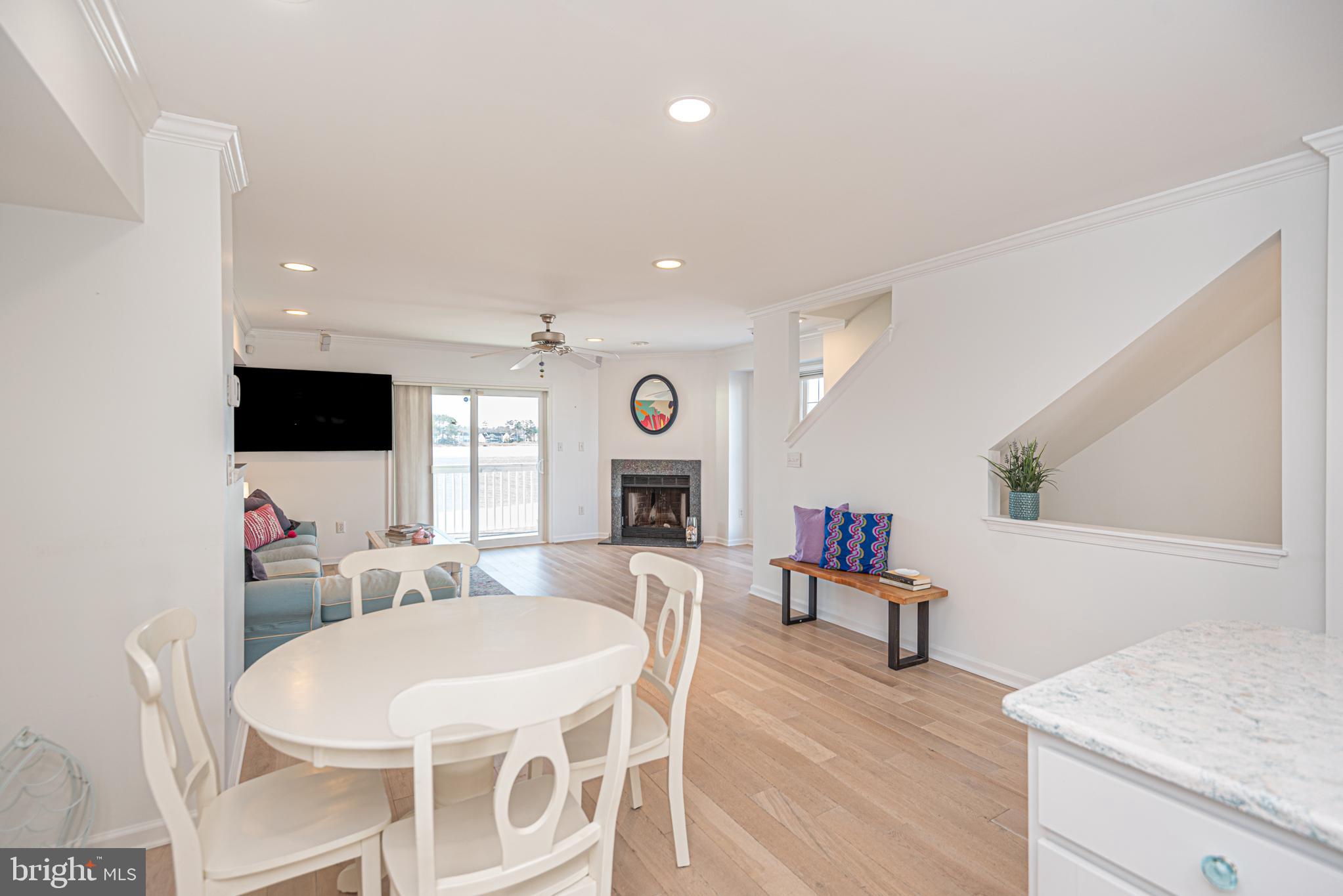 37845 Salt Grass Cove, Unit 89 Ocean View, DE 19970 - Photo 22 of 83 a living room with furniture a fireplace and a flat screen tv