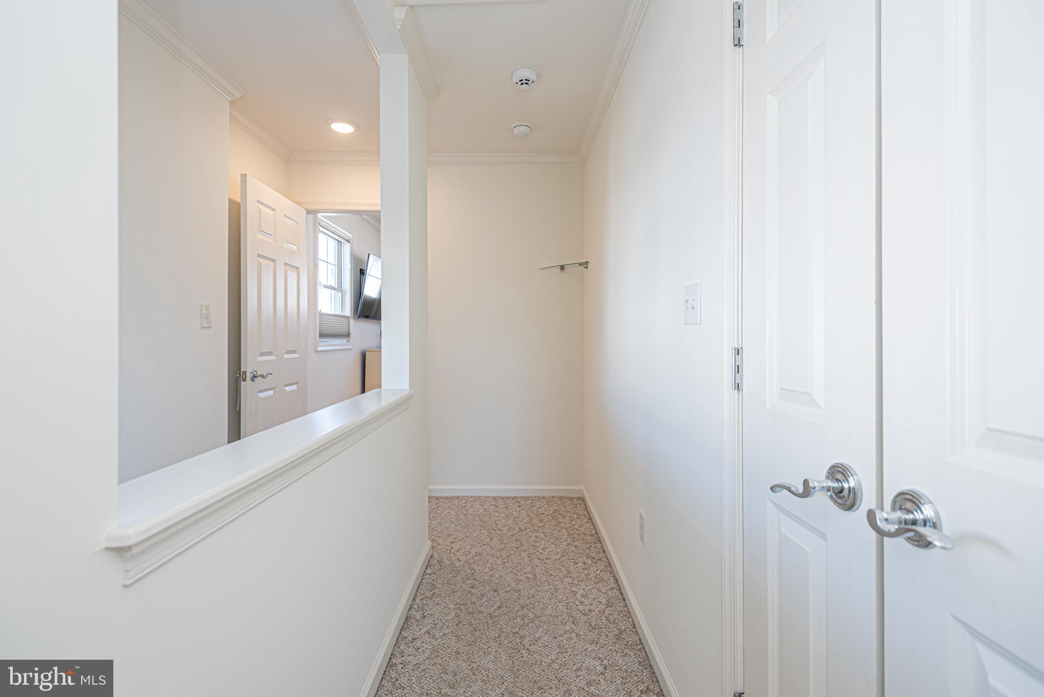 37845 Salt Grass Cove, Unit 89 Ocean View, DE 19970 - Photo 40 of 83 a view of a hallway with a white walls