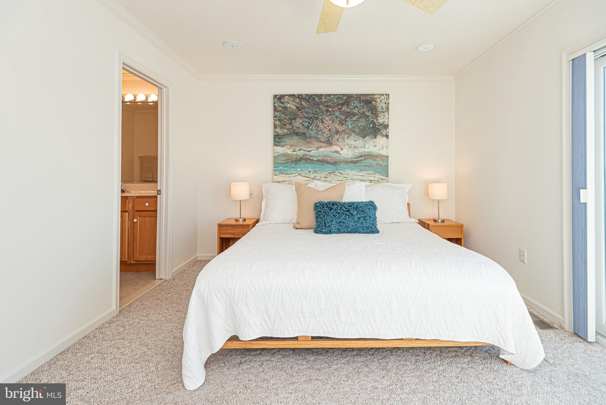 37845 Salt Grass Cove, Unit 89 Ocean View, DE 19970 - Photo 42 of 83 a bedroom with a bed and painting on the wall