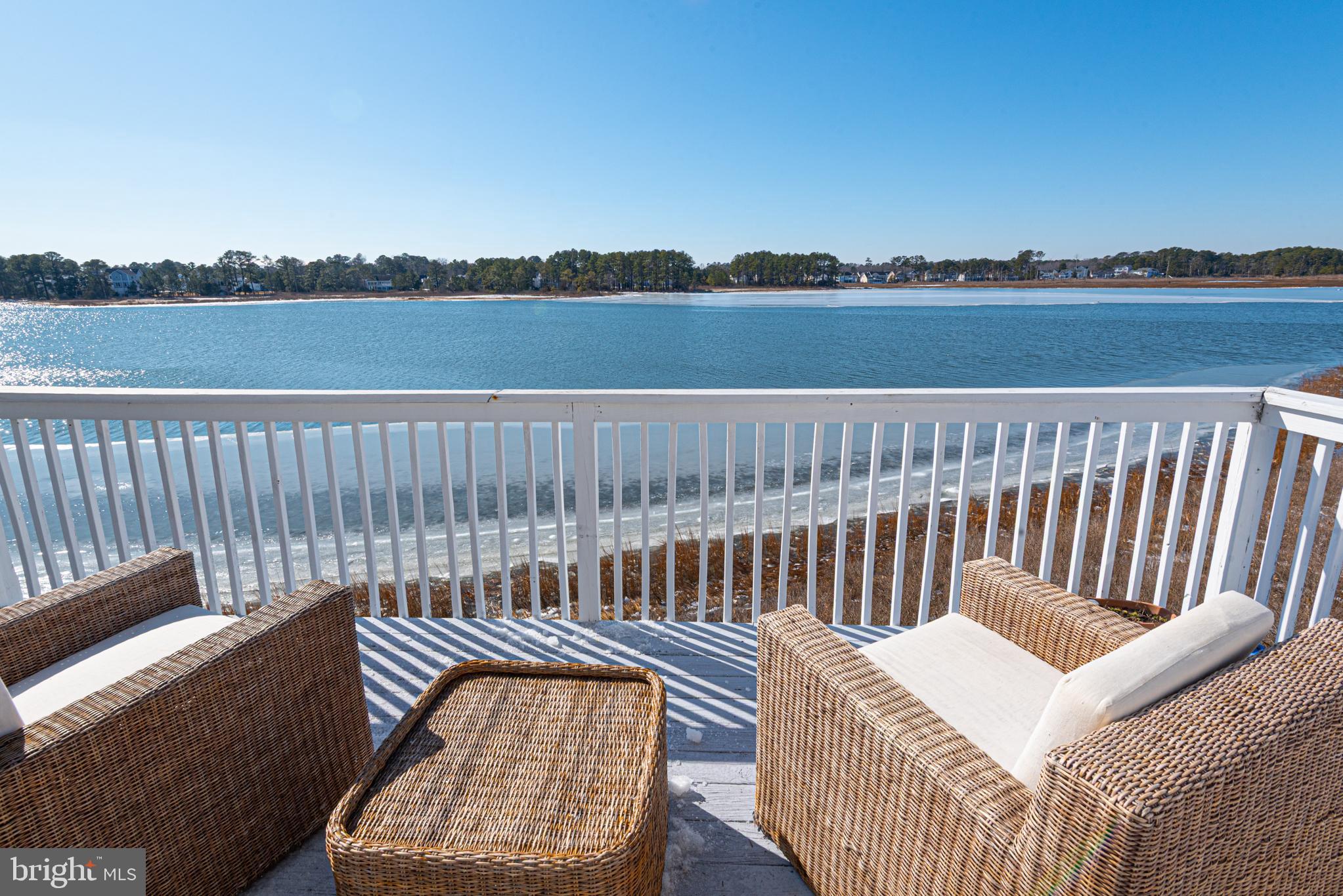 37845 Salt Grass Cove, Unit 89 Ocean View, DE 19970 - Photo 46 of 83 a view of a roof deck with wooden floor and a floor to ceiling window