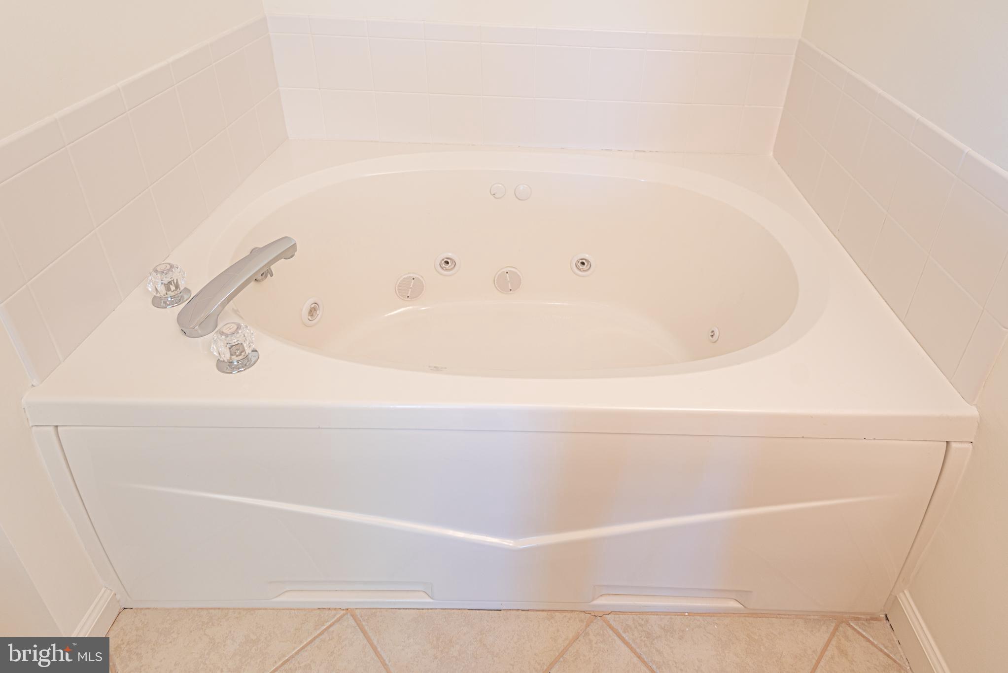 37845 Salt Grass Cove, Unit 89 Ocean View, DE 19970 - Photo 56 of 83 a bathroom with a bathtub
