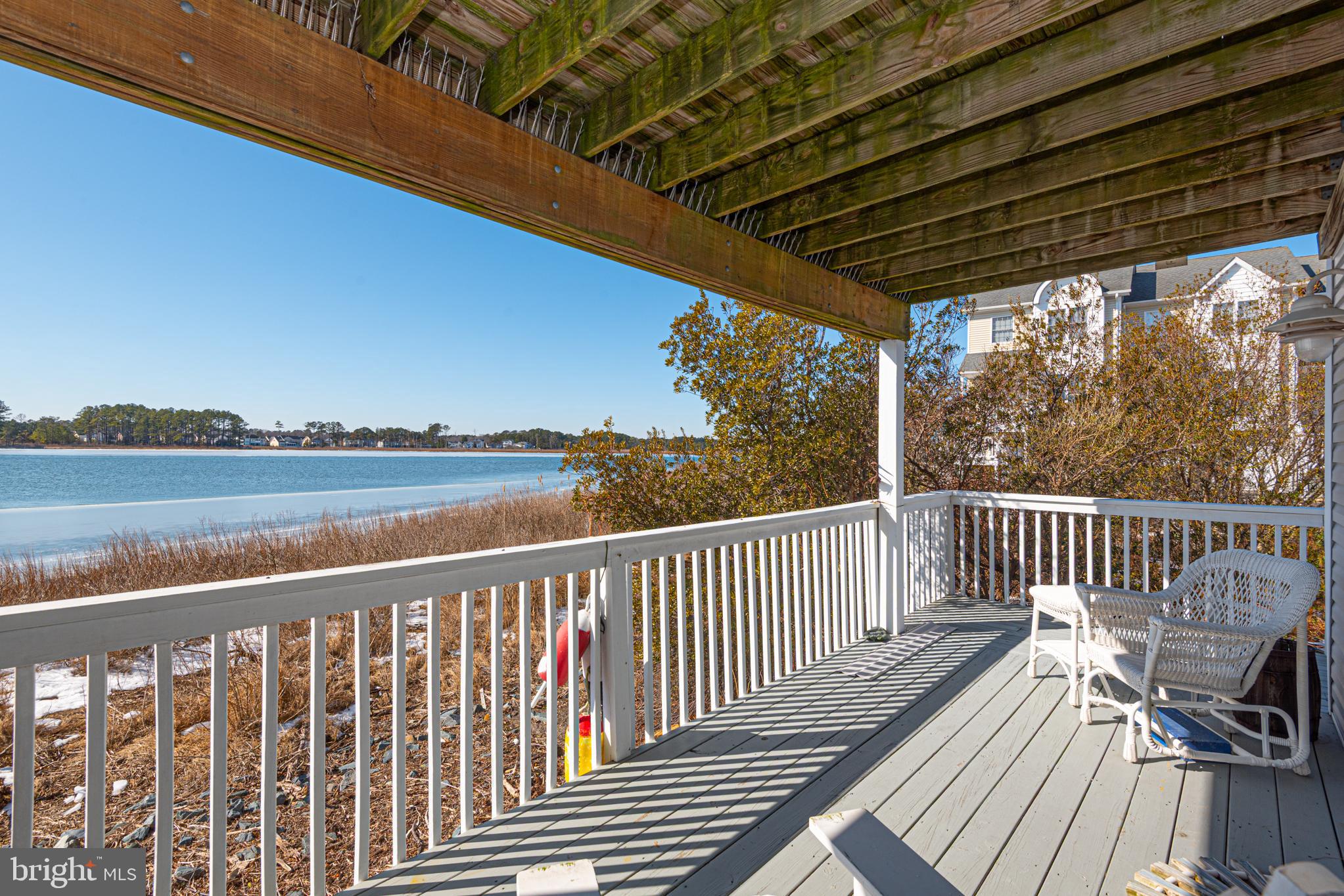 37845 Salt Grass Cove, Unit 89 Ocean View, DE 19970 - Photo 64 of 83 a view of a deck with wooden floor and outdoor space