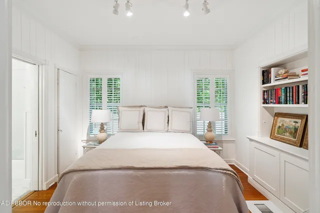 a bedroom with a bed and a book shelf