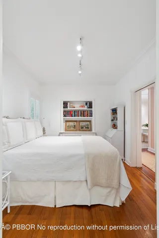 a bedroom with a bed and a night stand