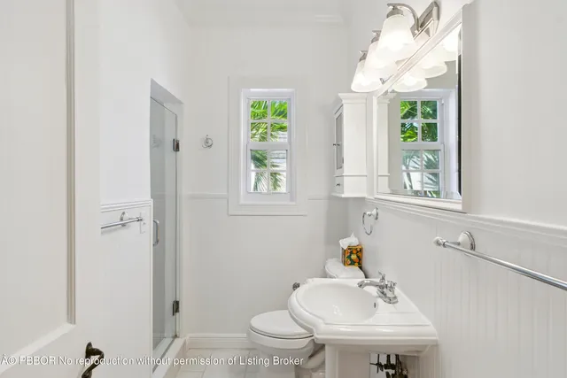 a bathroom with a sink a toilet and a window