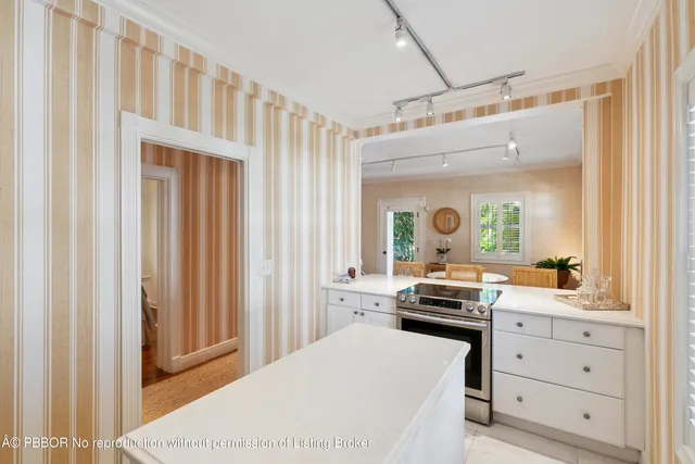 a kitchen with a refrigerator and white cabinets