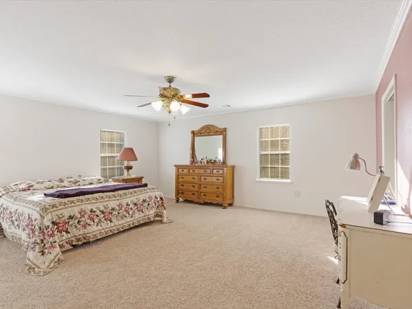 a bedroom with bed and window