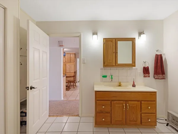 a bathroom with a sink a vanity a mirror and a toilet