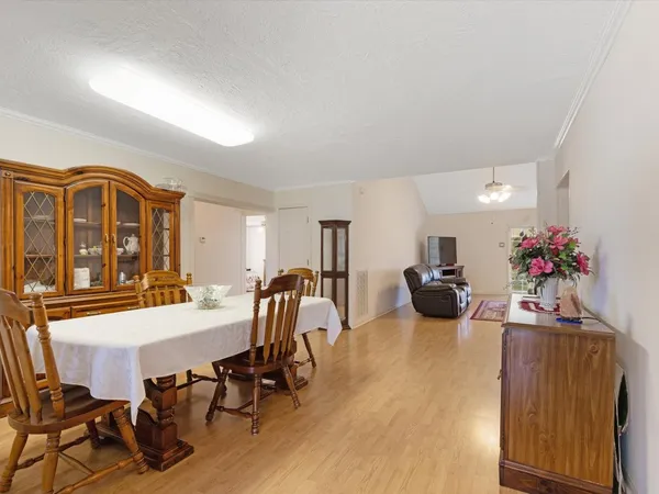 a view of a dining room with furniture and a chandelier