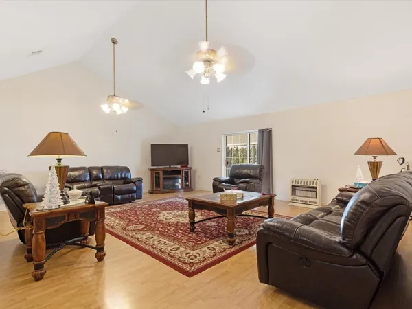 a living room with furniture a couch and a chandelier