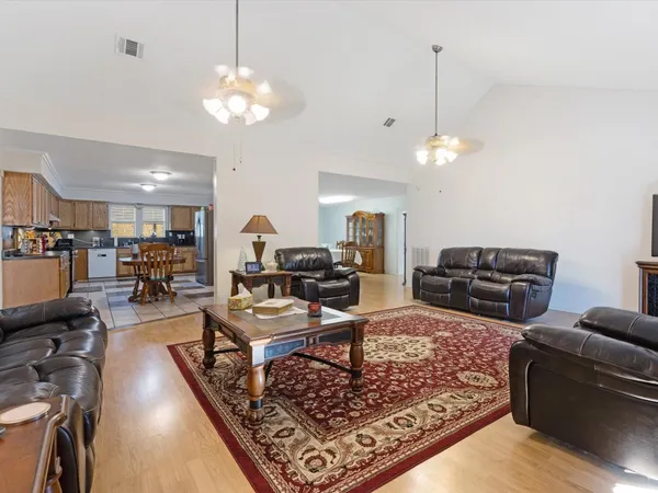 a living room with furniture a table and a flat screen tv