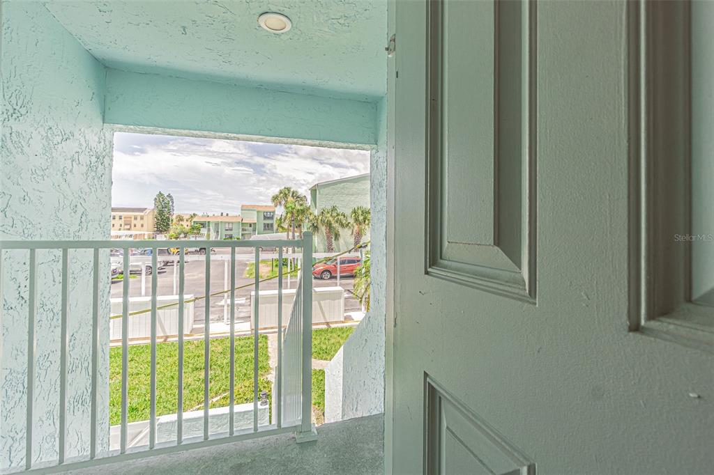 1 Windrush Boulevard, Unit 54 Indian Rocks Beach, FL 33785 - Photo 17 of 37 a view of a glass door with a yard from a window
