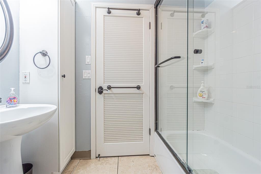 1 Windrush Boulevard, Unit 54 Indian Rocks Beach, FL 33785 - Photo 19 of 37 a bathroom with a shower and a sink
