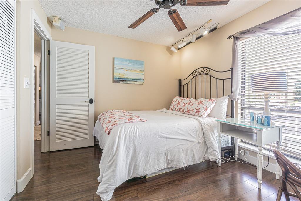 1 Windrush Boulevard, Unit 54 Indian Rocks Beach, FL 33785 - Photo 24 of 37 a bedroom with a bed and a table