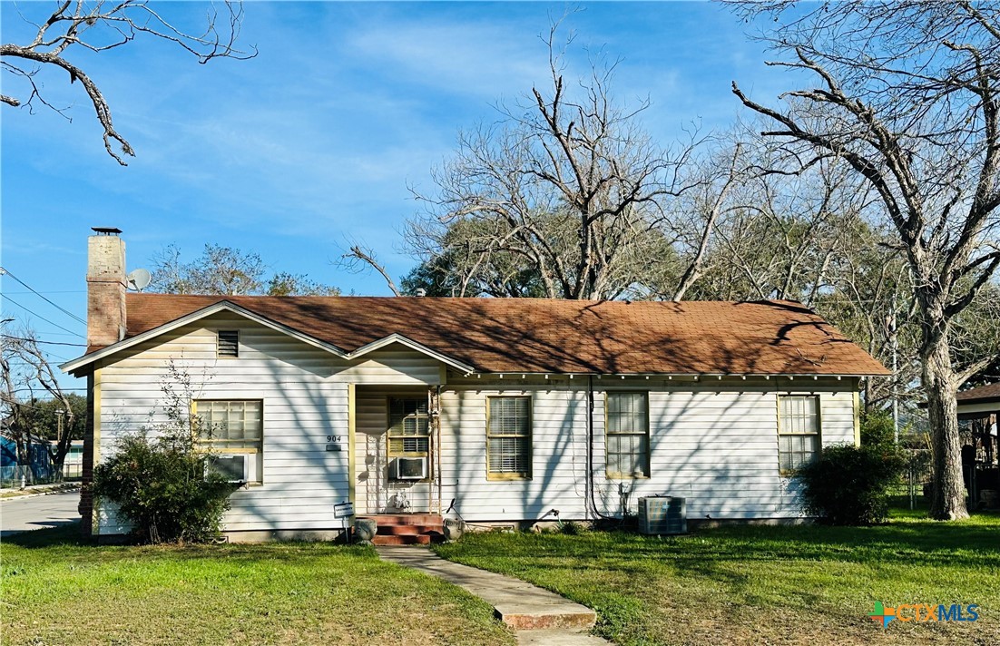 a front view of house with a garden