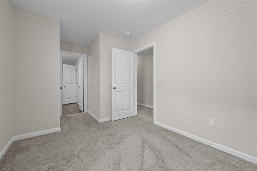 115 Adger Road Pendleton, SC 29670 - Photo 22 of 36 A well-maintained room features soft carpet flooring, ready for personalization.