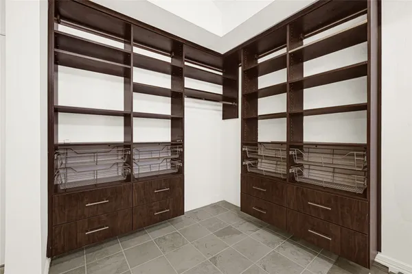 a kitchen with stainless steel appliances cabinets and a large window