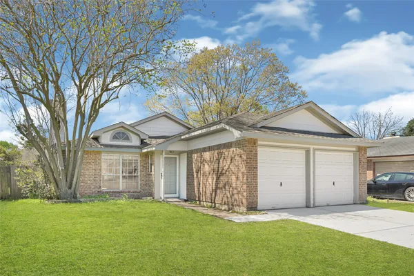 a big house with palm trees in the background